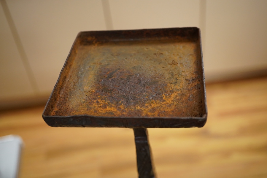 An iron candle stick with incised geometric decoration, 49cm high